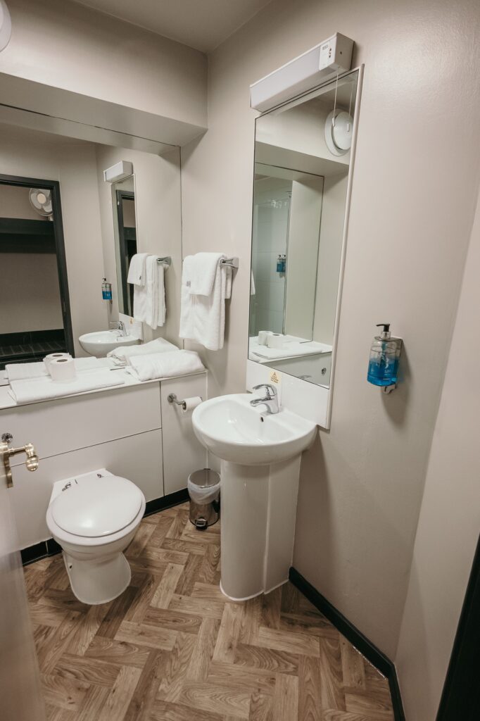 bathroom toilet, mirror and sink