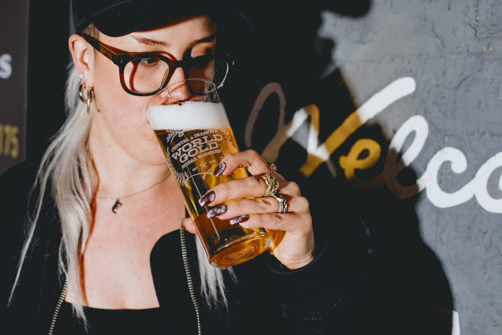 A woman drinking a pint of Diamond.