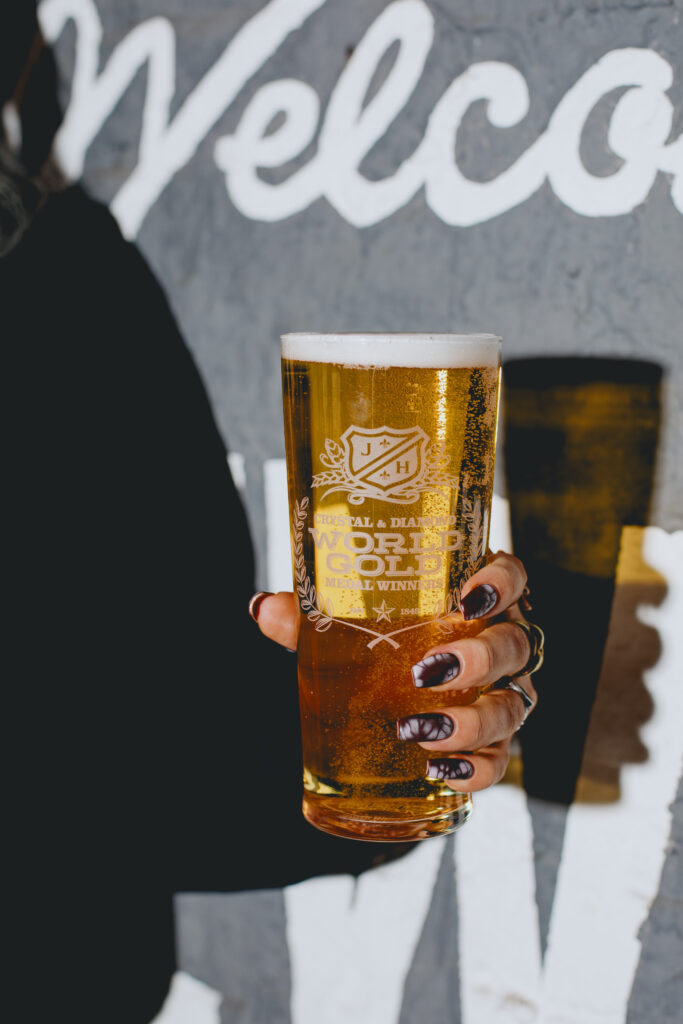 A woman holding a pint of Diamond.