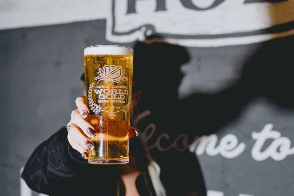 A woman drinking a pint of Diamond.