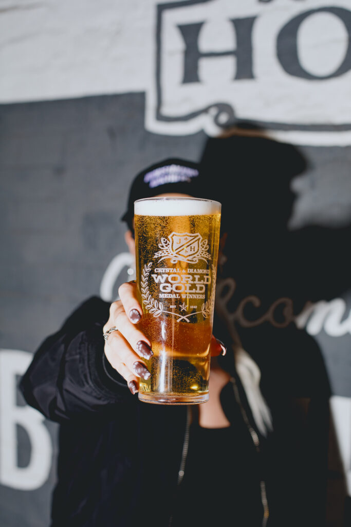 A woman drinking a pint of Diamond.