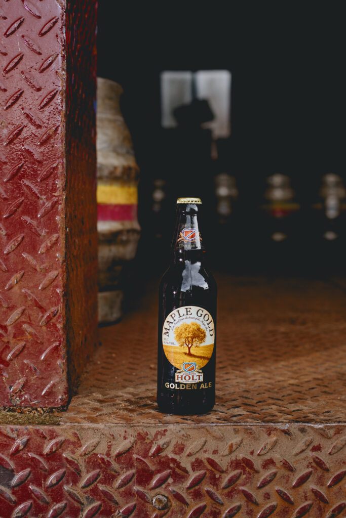 A bottle of Maple Gold Ale sat on the floor.