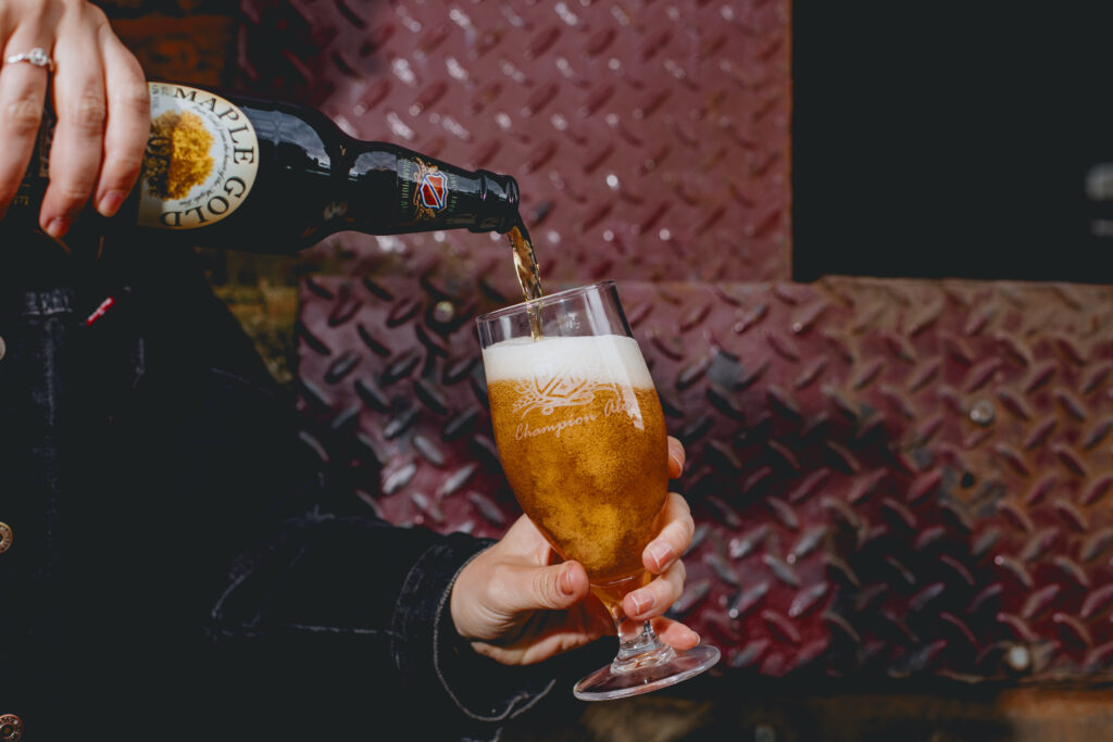 A bottle of Maple Gold being pored into a glass.