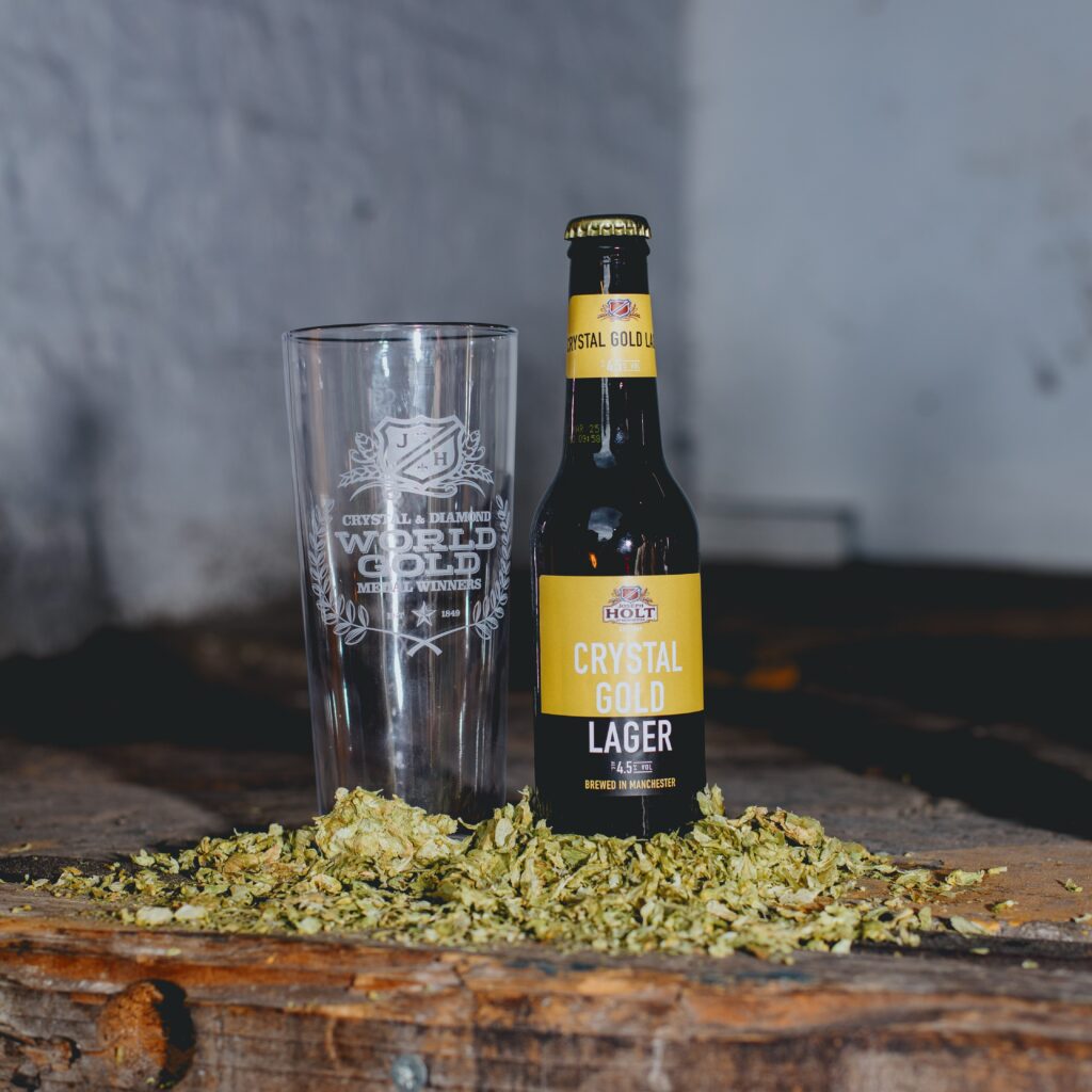 Crystal Gold lager bottle next to a glass.