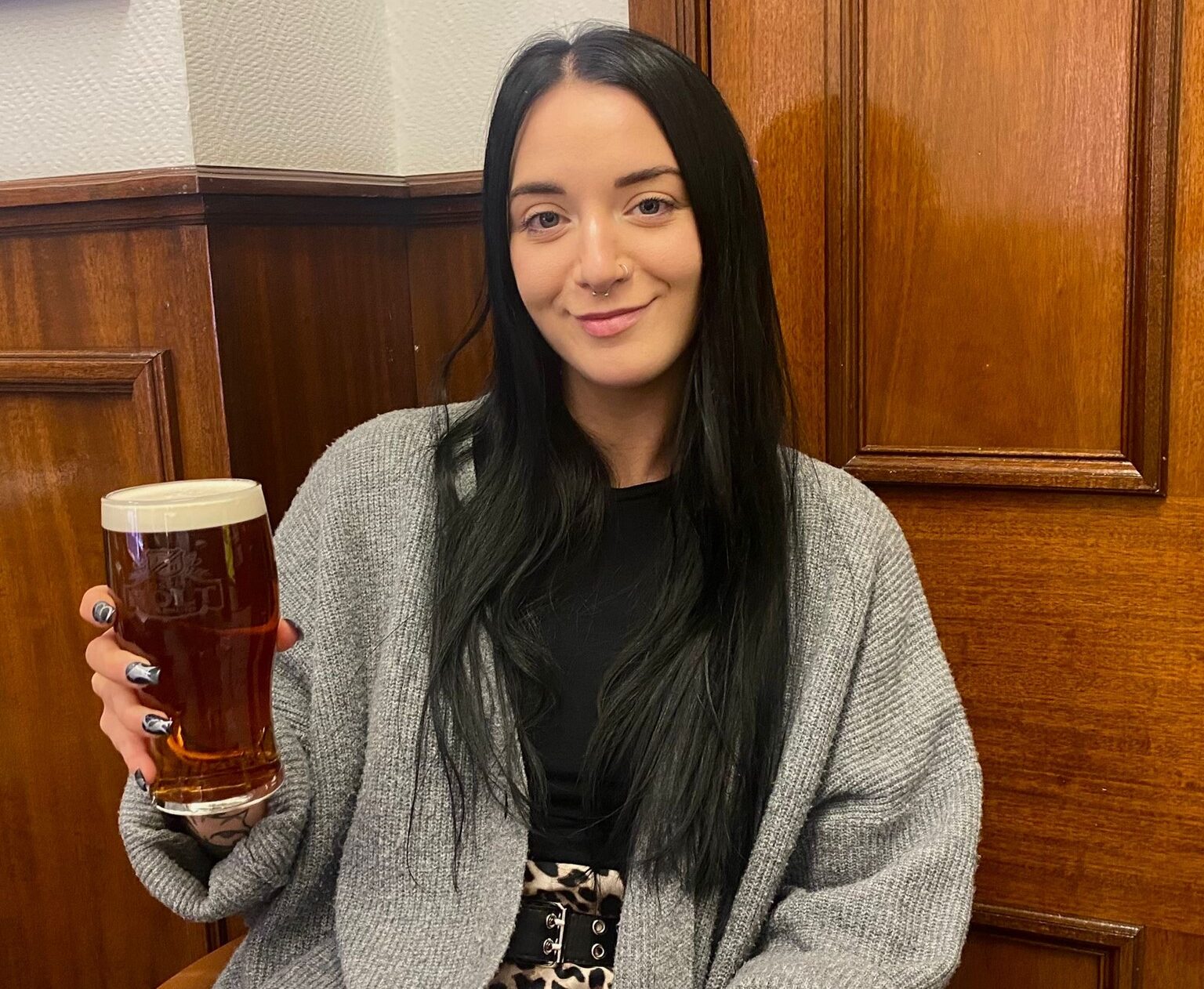 A girl holding a pint.