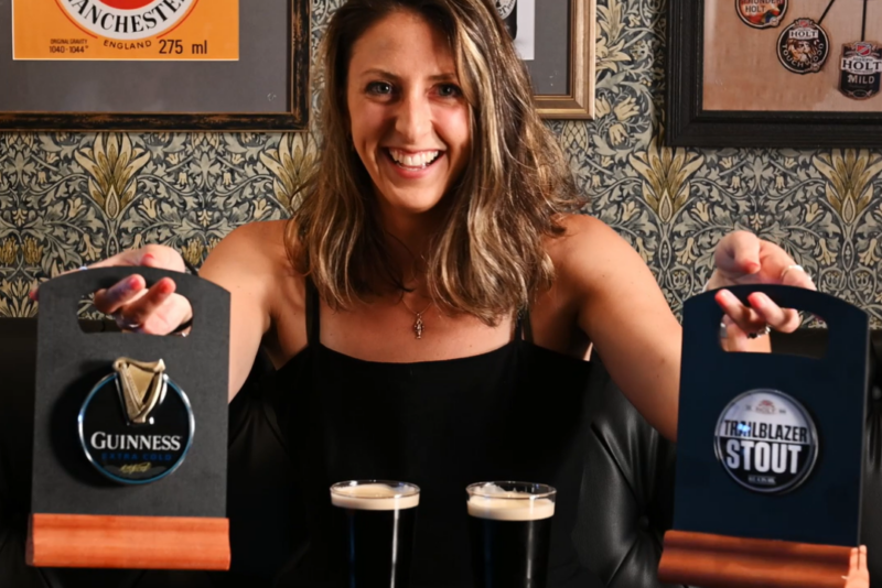 A woman in front of 2 pints of stout